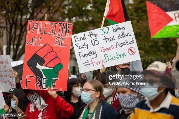 Students from Brooklyn College and supporters hold signs during a pro-Palestinian demonstration at the entrance of the campus. The pro-Palestinian...