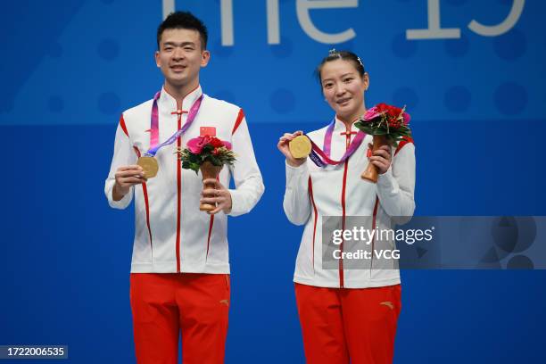 Gold medalists Zheng Siwei and Huang Yaqiong of Team China pose during the medal ceremony for the Badminton - Mixed Doubles Final on day 14 of the...