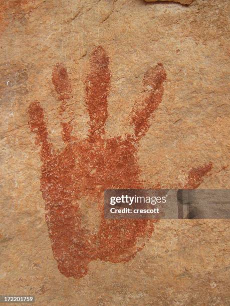 ancient print of a left hand on a rocky wall - cave painting stock pictures, royalty-free photos & images