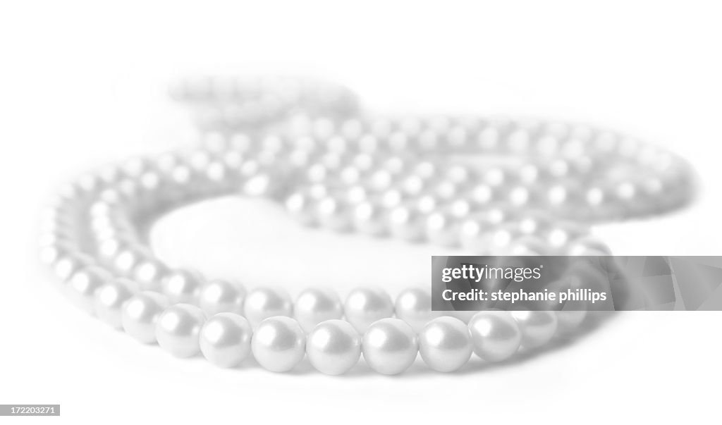 Pearl Necklace Lying on a White Background