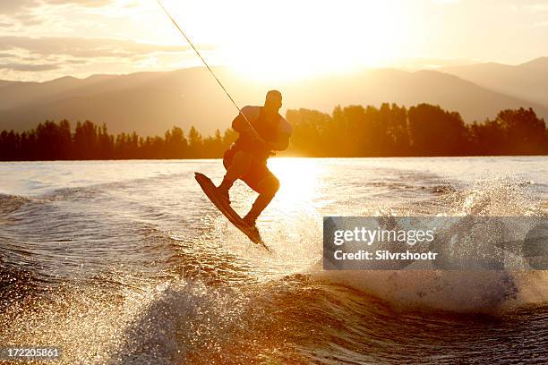 wakeboarder at sunrise - jumping into lake stock pictures, royalty-free photos & images