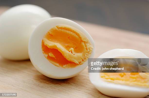 sliced boiled and peeled hens egg - boiled egg stock pictures, royalty-free photos & images