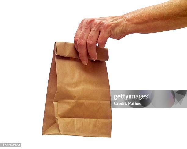female hand holding out a lunch bag - lunch bag white background stock pictures, royalty-free photos & images