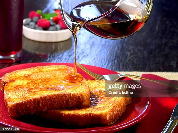 fresh french toasts with pouring syrup - pain perdu stock pictures, royalty-free photos & images