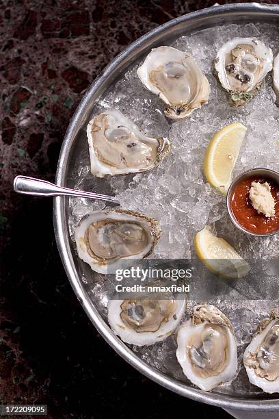 fresh oysters and lime in a bucket of ice - oyster clam stock pictures, royalty-free photos & images