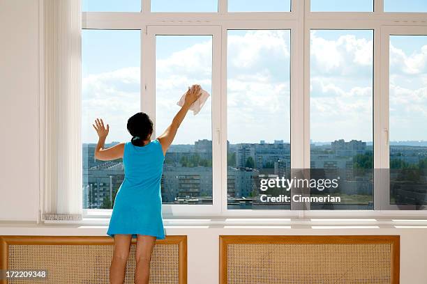 a female in a blue dress cleaning tall windows - huge task stock pictures, royalty-free photos & images