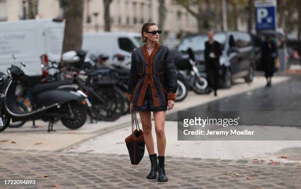 Vera van Erp is seen outside Chanel show wearing black sunnies, leather Chanel necklace with Chanel logo, black leather teddy fur Chanel jacket,...