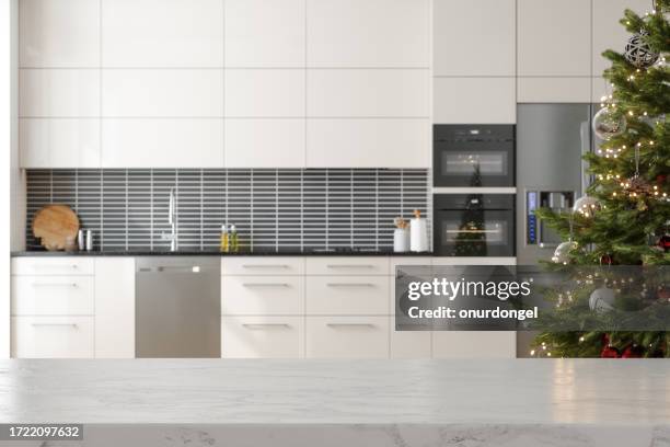 empty white marble countertop and christmas tree with blurred kitchen background - counter surface level stock pictures, royalty-free photos & images