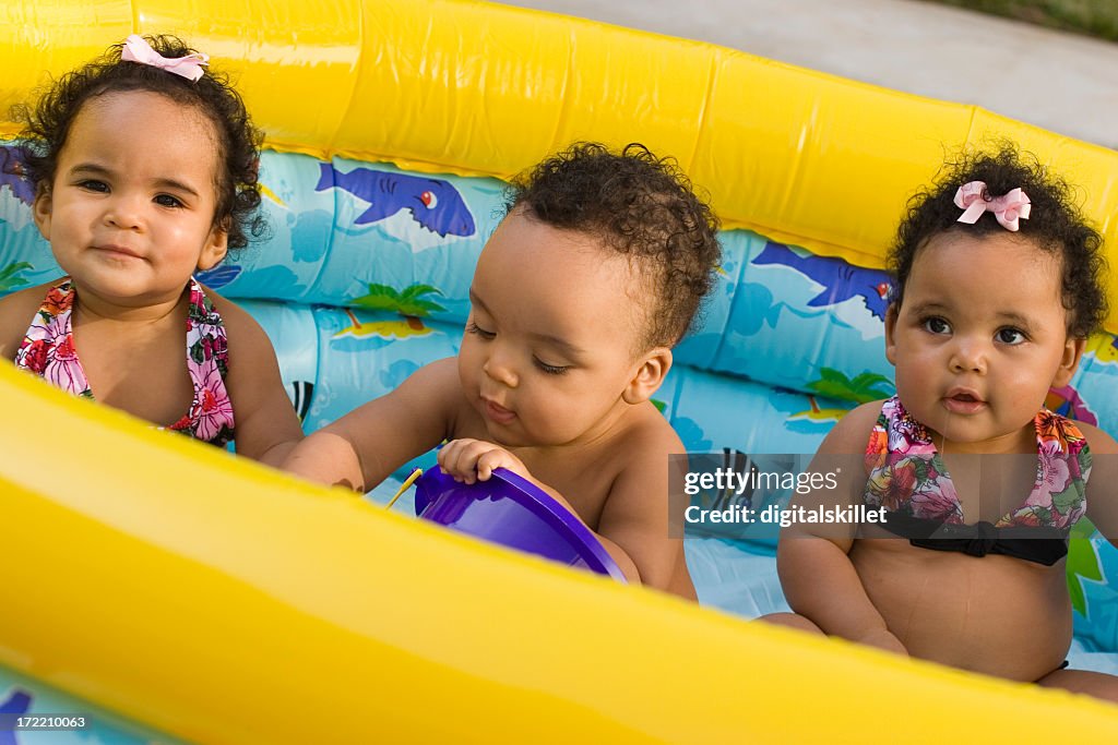 Triplets Having fun in the pool