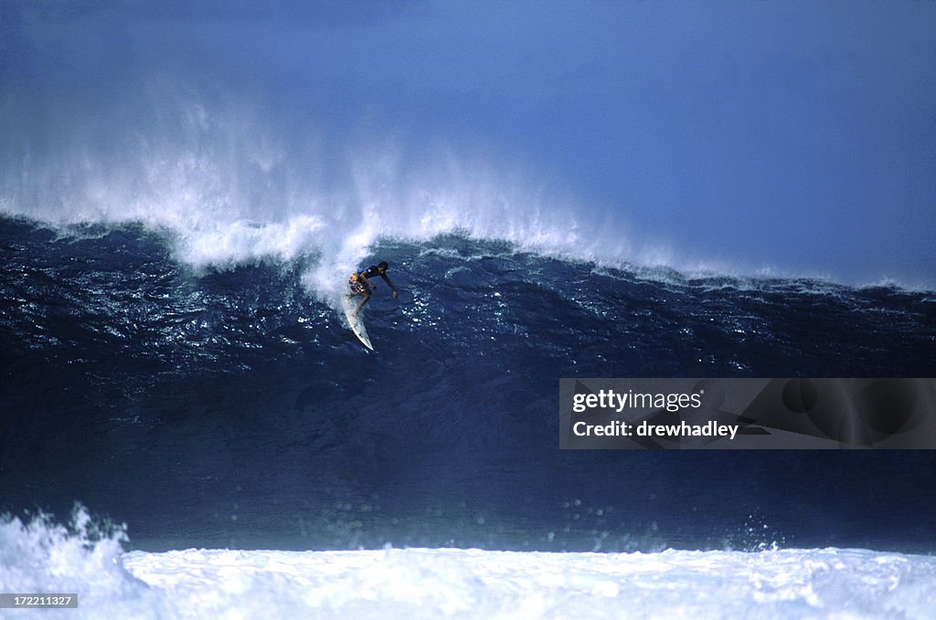 Surfer dropping in at big Pipeline, Hawaii