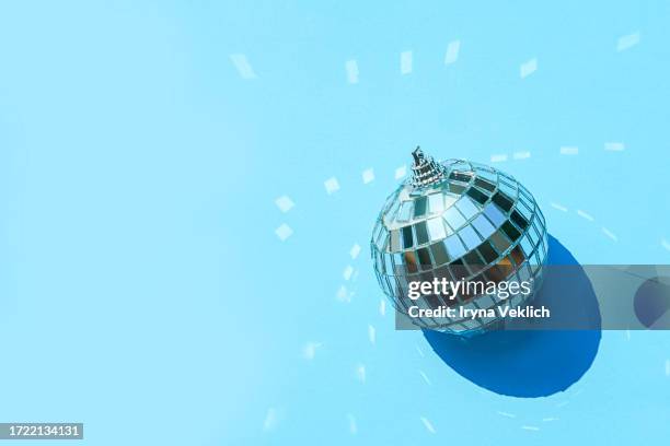 silver mirror disco ball on blue color background. merry christmas, happy new year invitation. - silver disco ball stock pictures, royalty-free photos & images