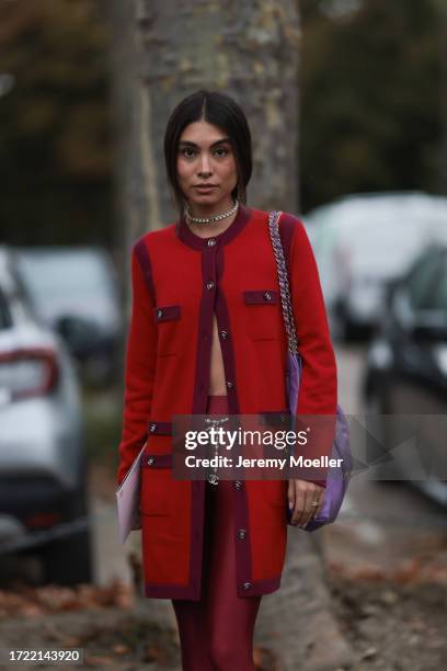 Fer Millán Delaroière is seen outside Chanel show wearing Chanel pearl necklace, red and lilac Chanel cardigan, lilac Chanel 22 tote bag, red high...