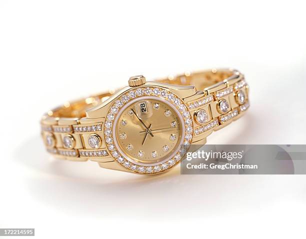 a gold watch with embedded diamonds - diamond jewellery stock pictures, royalty-free photos & images