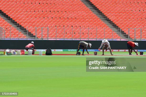 Ground stuff work in the pitch of the Narendra Modi Stadium in Ahmedabad October 13 on the eve of the 2023 ICC Men's Cricket World Cup one-day...