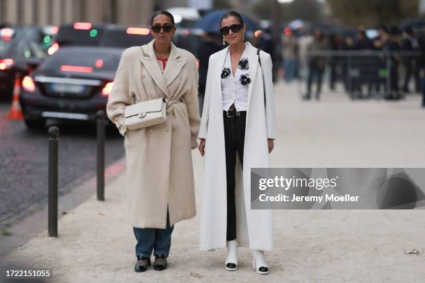 Hanna MW wears black. Sunnies, creme white belted coat, white Chanel Flap Bag Medium size, denim jeans and black and crystal net shoes & Darja...