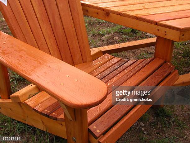 close-up of wet adirondack chair standing on the grass - adirondack chair closeup stock pictures, royalty-free photos & images