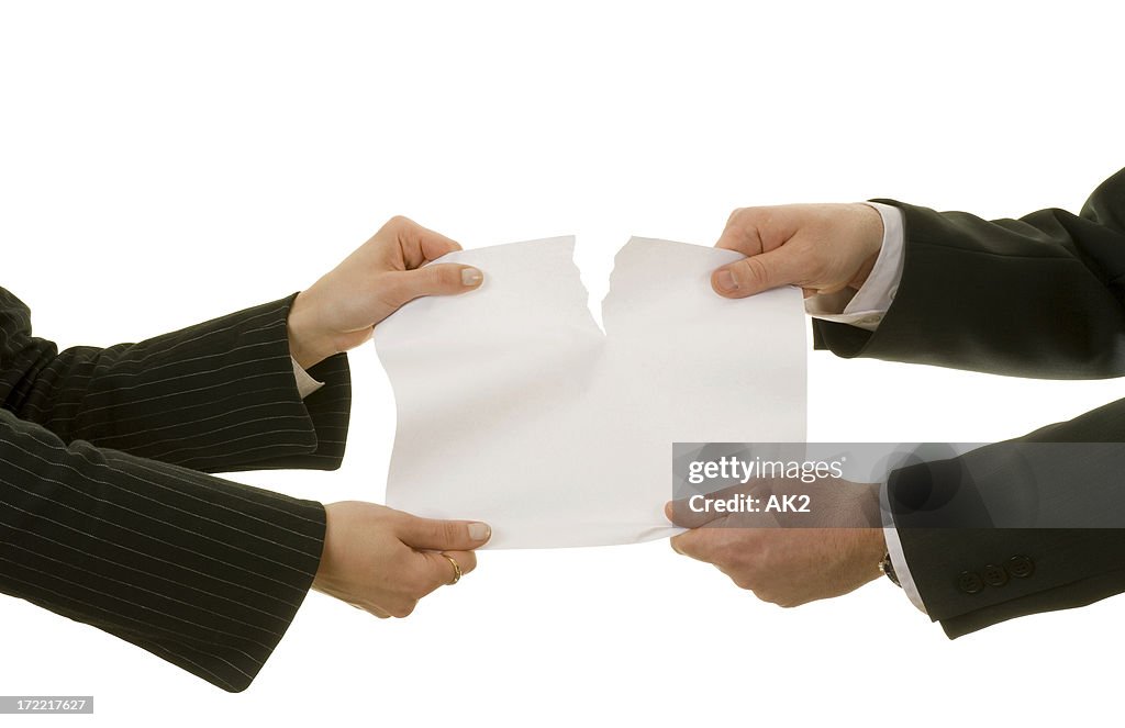 Couple tearing a paper