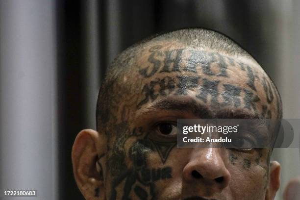 Gang members of the 'Mara Salvatrucha' and 'Barrio 18' are seen in a cell at the Terrorism Confinement Center , of the municipality of Tecoluca, in...