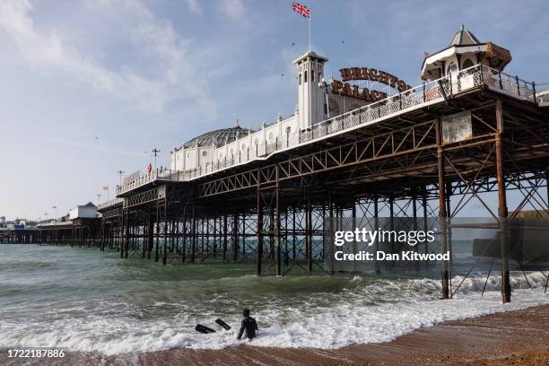 Snorkeler makes their way through the surf under Brighton Pier on October 07, 2023 in Brighton, England. The UK is experiencing two very different...