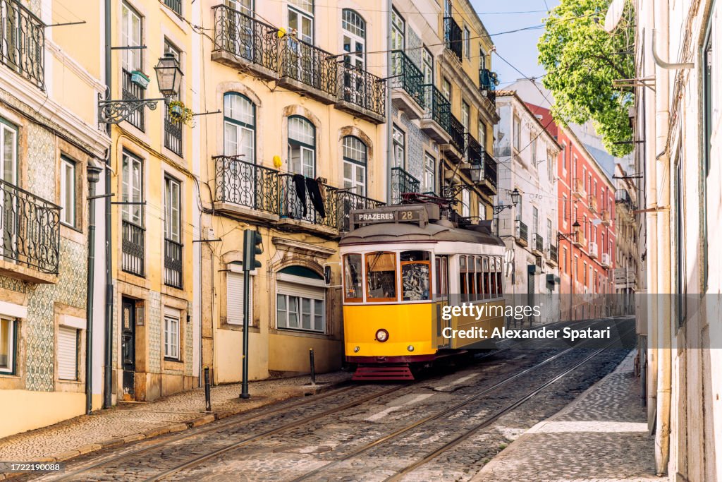 Old yellow tram on the streets of Alfama, Lisbon, Portugal