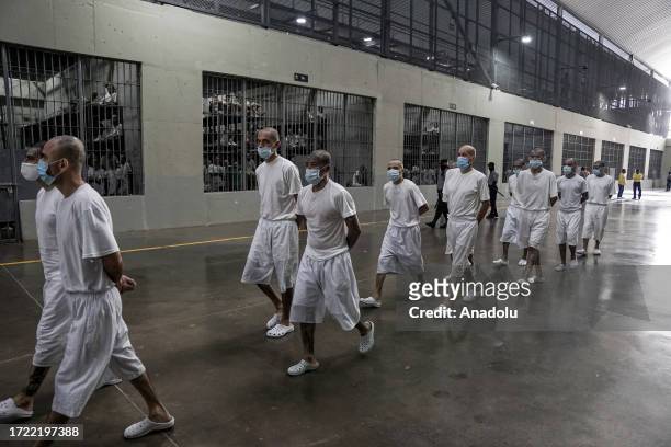 Gang members of the 'Mara Salvatrucha' and 'Barrio 18' are seen in a cell at the Terrorism Confinement Center , of the municipality of Tecoluca, in...