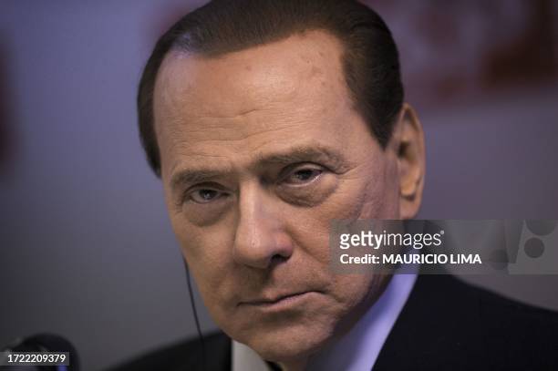 Italy's Prime Minister Silvio Berlusconi listens to a question during a press conference after a ceremony with Brazil's President Luiz Inacio Lula da...
