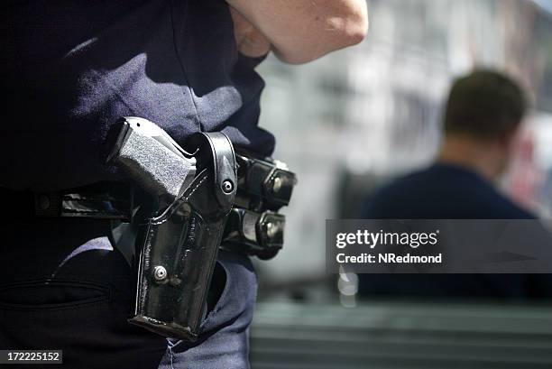 police officer with handgun in holster - holster stock pictures, royalty-free photos & images