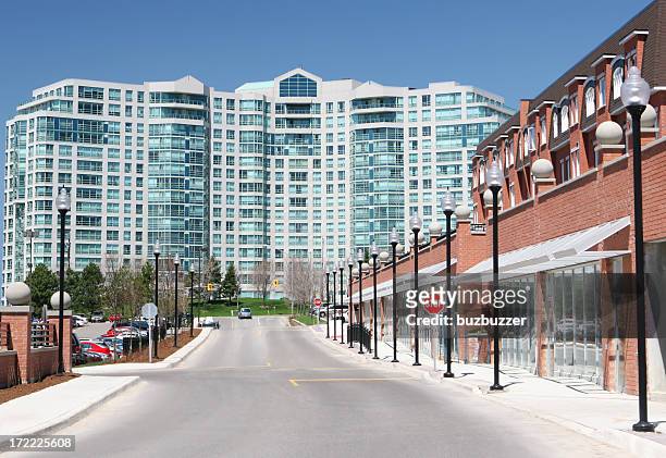 commercial street near a large apartment building - community health centre stock pictures, royalty-free photos & images