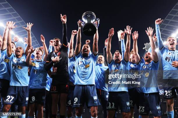 Fabio Gomes of Sydney FC lifts the Australia Cup trophy and celebrates victory with team mates after the 2023 Australia Cup Final match between...