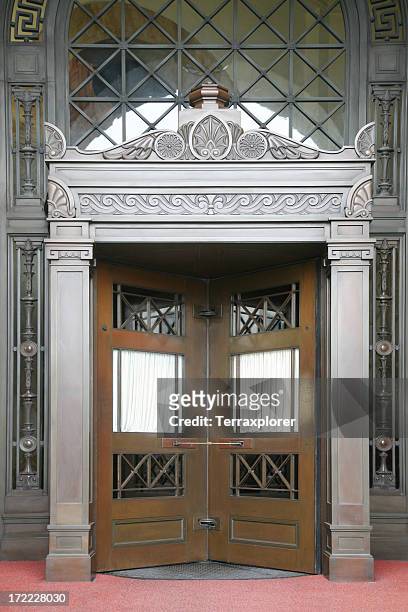 revolving doors in a fancy building - deco district stock pictures, royalty-free photos & images