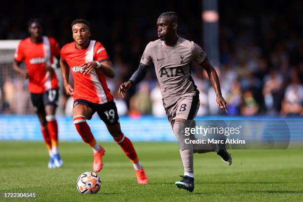 Yves Bissouma of Tottenham Hotspur runs with the ball whilst under pressure from Jacob Brown of Luton Town during the Premier League match between...