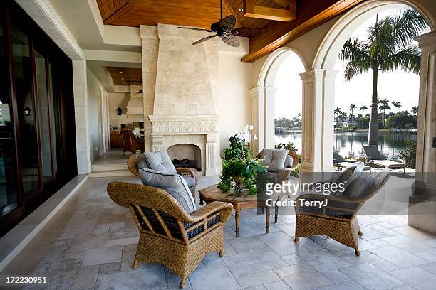 beautiful patio furniture at estate home overlooking bay - florida mansions stockfoto's en -beelden