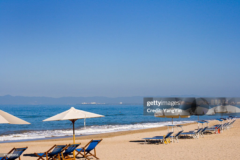 Beach View at Puerto Vallarta, Mexico with Chairs and Umbrellas