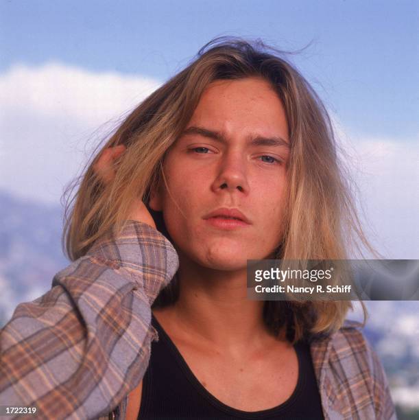 Outdoor headshot portrait of American actor River Phoenix , 1991.