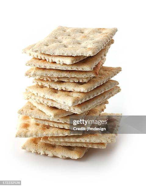 a pile of crackers on white background - crackers stock pictures, royalty-free photos & images