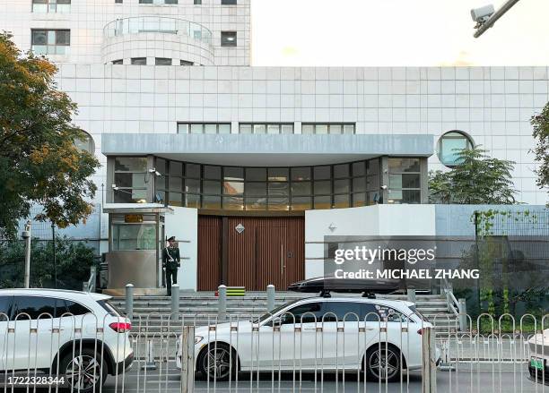 Chinese paramilitary policeman stands guard at the entrance to the Israeli embassy in Beijing on October 13 after an embassy employee was attacked...