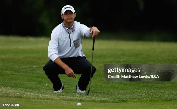 Lloyd Saltman of Archerfield Links lines up a putt on the 18th green during The Open Championship Local Final Qualifying at Musselburgh golf club on...