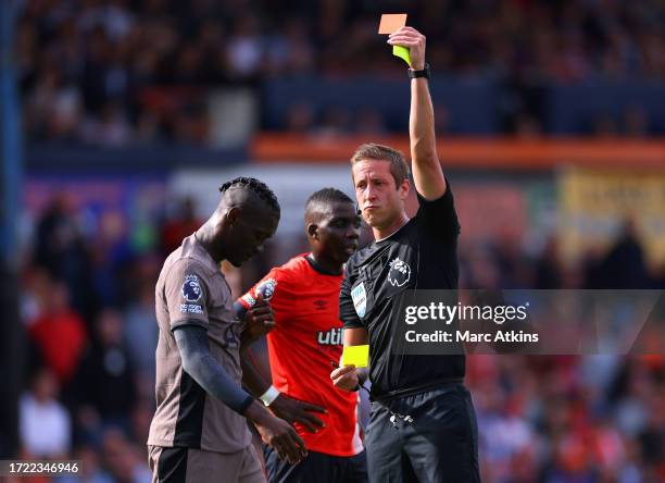 Referee, John Brooks shows a red card to Yves Bissouma of Tottenham Hotspur during the Premier League match between Luton Town and Tottenham Hotspur...