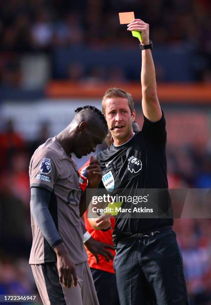 Referee, John Brooks shows a red card to Yves Bissouma of Tottenham Hotspur during the Premier League match between Luton Town and Tottenham Hotspur...