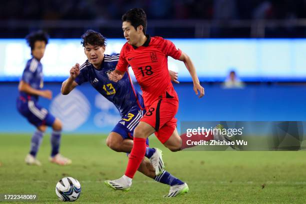 Lee Kangin of South Korea competes for the ball during the 19th Asian Game men's gold medal match between South Korea and Japan at Huanglong Sports...