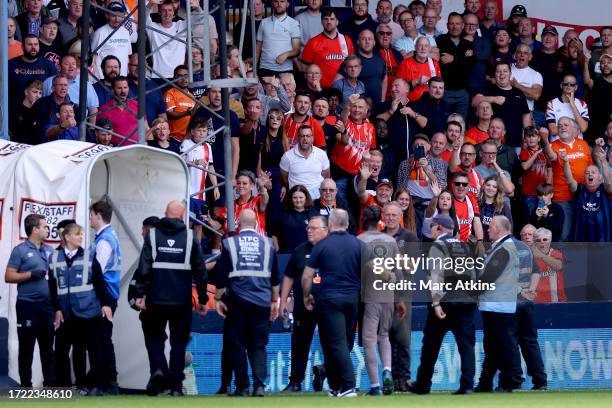 Luton Town fans react as Yves Bissouma of Tottenham Hotspur leaves the pitch after being shown a red card during the Premier League match between...