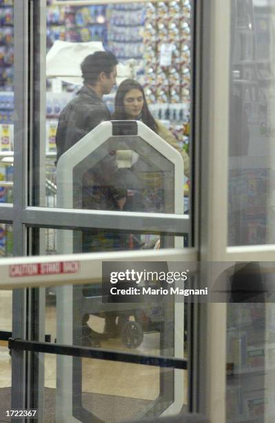 Actor Benjamin Bratt walks with his baby girl, Sophia Rosalinda Bratt, while shopping along with his wife, actress Talisa Soto December 19, 2002 in...