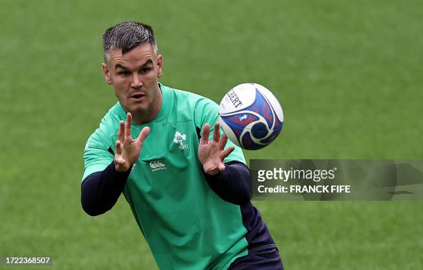 Ireland's fly-half Jonathan Sexton catches the ball during a training session at the Stade de France, in Saint-Denis, on the outskirts of Paris, on...