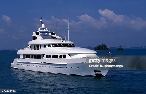 a luxury yacht out in the ocean - super yacht stock pictures, royalty-free photos & images