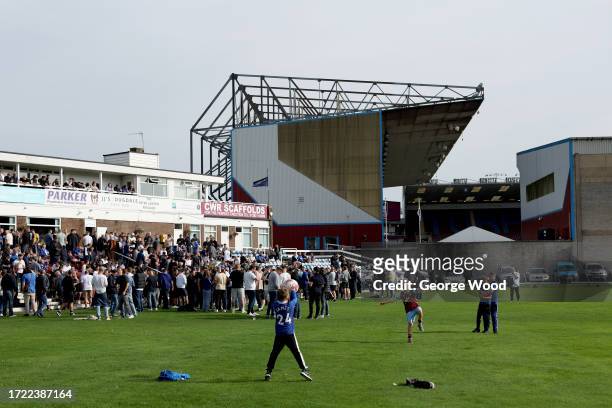 General view outside the stadium as fans are seen playing football at Burnley Cricket Club prior to the Premier League match between Burnley FC and...