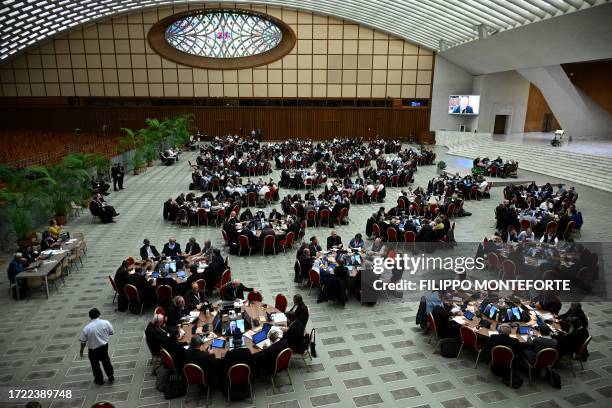 Delegates take part in the 16th Ordinary General Assembly of the Synod of Bishops, at Paul VI Audience Hall at the Vatican, on October 13, 2023. The...