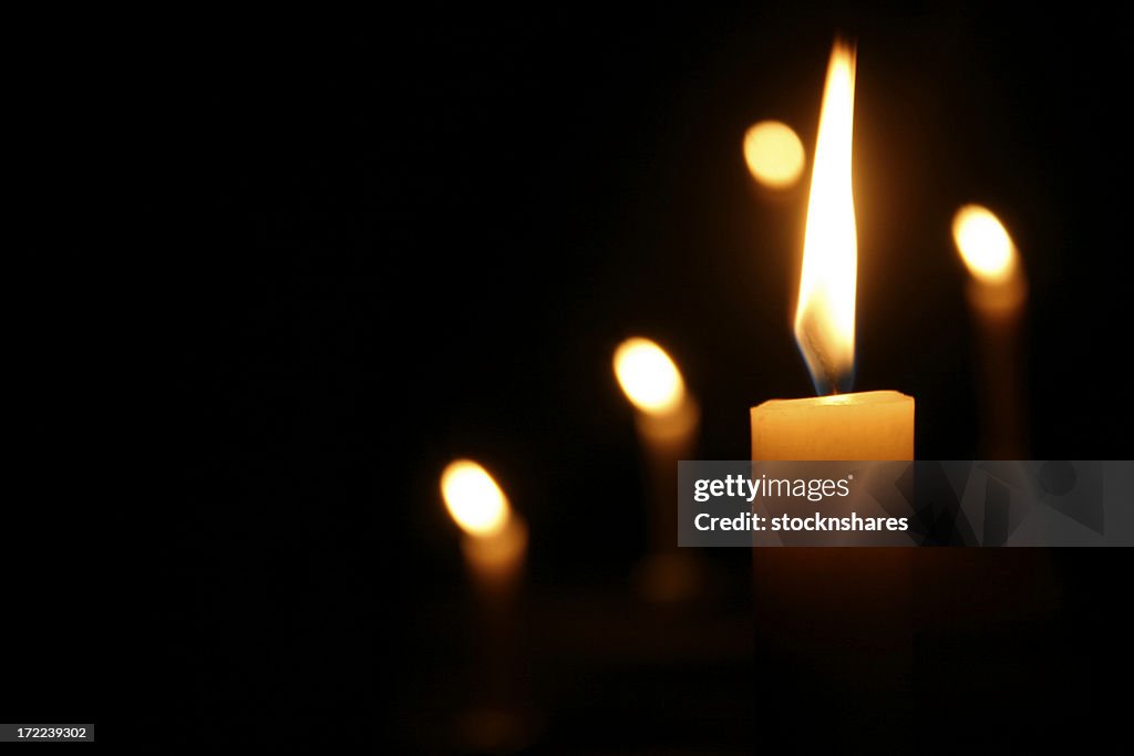 Candles Burning in Dark Church