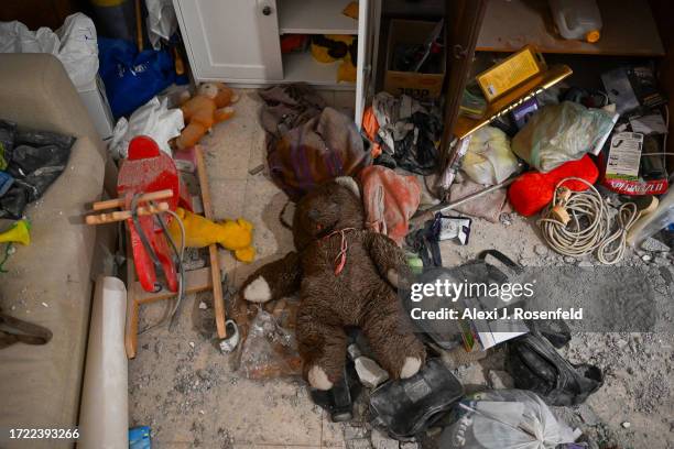 Teddy bear lies on the ground amongst the rubble at the Gat house, where five family members were kidnapped and three are still missing, after Hamas...