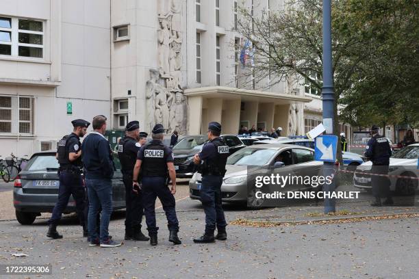 French police officers stand in front of the Gambetta high school in Arras, northeastern France on October 13 after a teacher was killed and two...