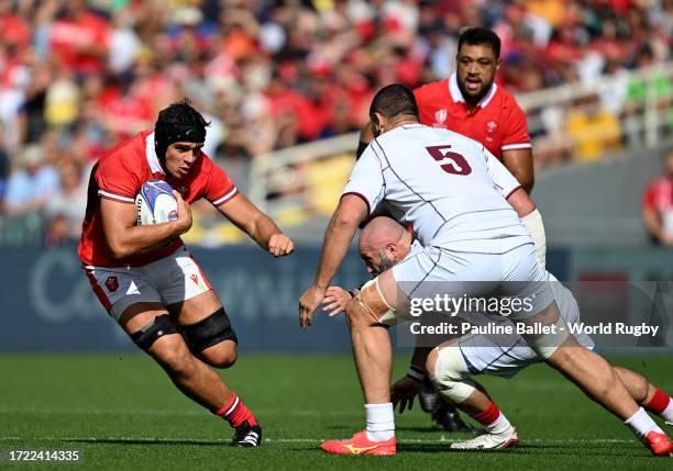 Dafydd Jenkins of Wales runs with the ball whilst under pressure from Konstantin Mikautadze and Shalva Mamukashvili of Georgia during the Rugby World...